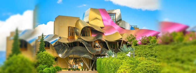 Trip Ukraine Reisetipps - Marqués de Riscal Design Hotel, Bilbao, Elciego, Spanien. Fantastisch galaktisch, unverkennbar ein Werk von Frank O. Gehry. Inmitten idyllischer Weinberge in der Rioja Region des Baskenlandes, bezaubert das schimmernde Bauobjekt mit einer Struktur bunter, edel glänzender verflochtener Metallbänder. Glanz im Baskenland - Es muss etwas ganz Besonderes sein. Emotional, zukunftsweisend, einzigartig. Denn in dieser Region, etwa 133 km südlich von Bilbao, sind Weingüter normalerweise nicht für die Öffentlichkeit zugänglich.